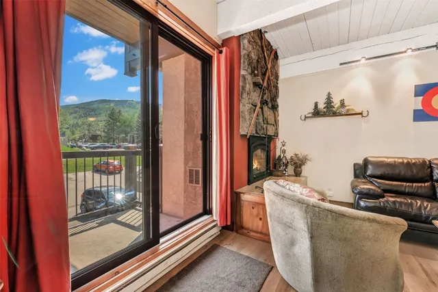 a living room with furniture and a floor to ceiling window