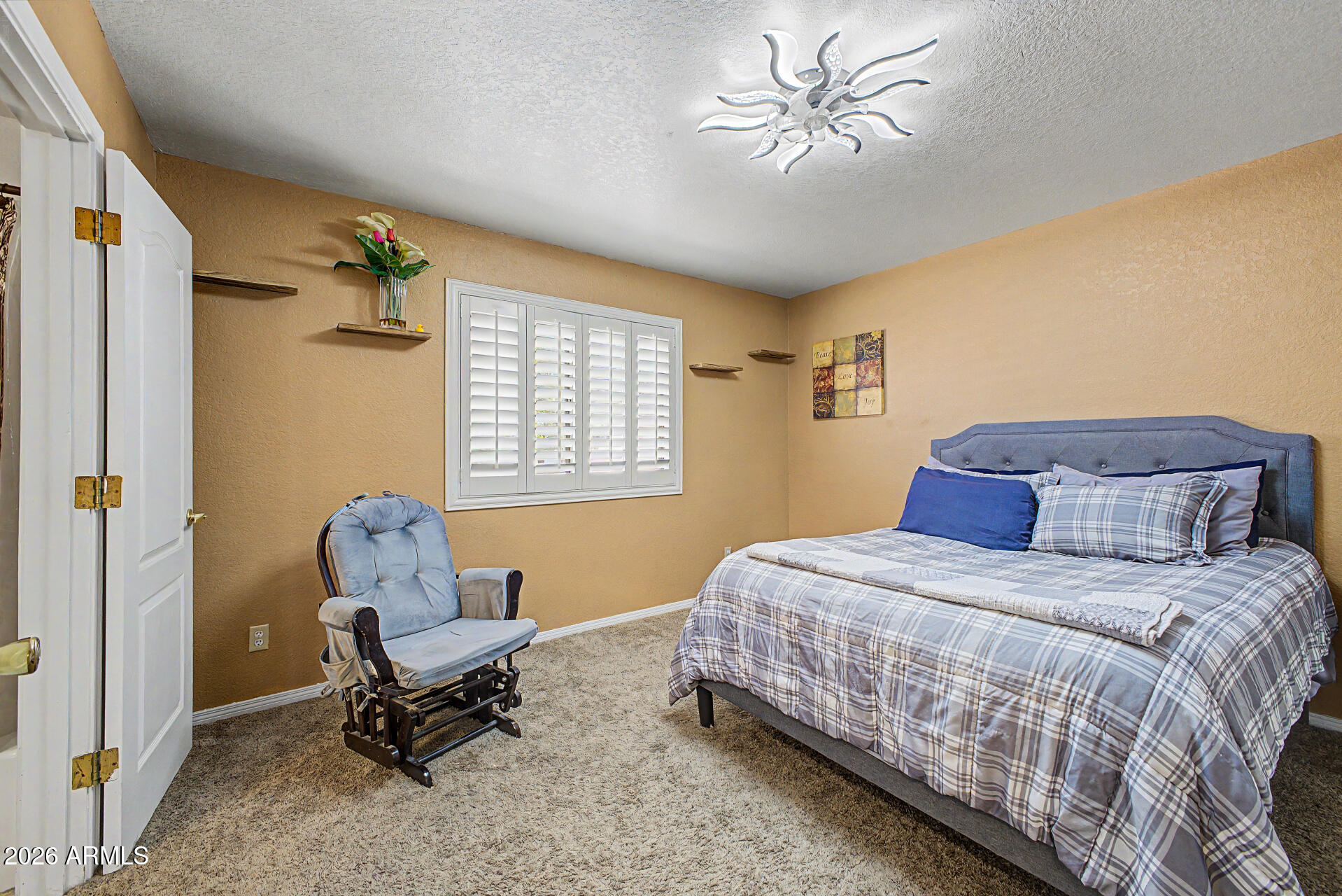 660 South Stardust Lane Apache Junction, AZ 85120 - Photo 10 of 15 a bedroom with a bed a chair and couch