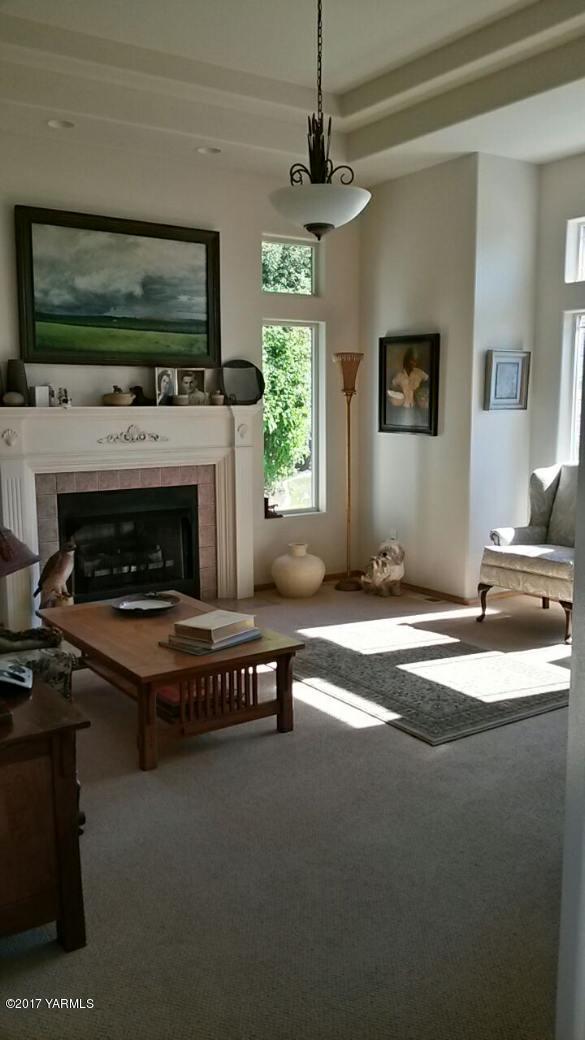 340 West Huntzinger Road Selah, WA 98942 - Photo 23 of 74 a living room with furniture a flat screen tv and a fireplace