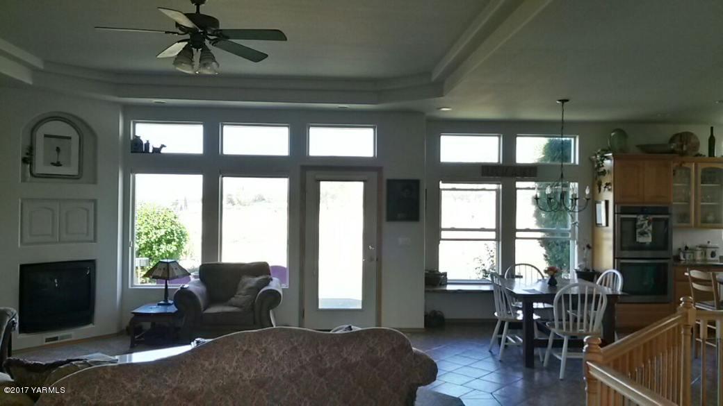 340 West Huntzinger Road Selah, WA 98942 - Photo 24 of 74 a living room with furniture windows and a fireplace