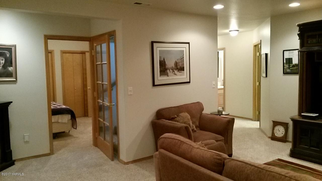 340 West Huntzinger Road Selah, WA 98942 - Photo 55 of 74 a living room with furniture a refrigerator and a flat screen tv