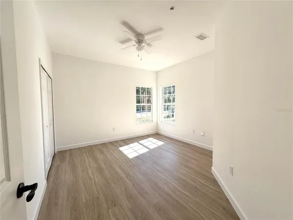 a bathroom with a granite countertop sink toilet a large mirror a bathtub and shower