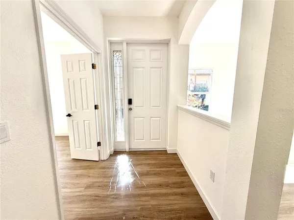 a view of a hallway with wooden floor