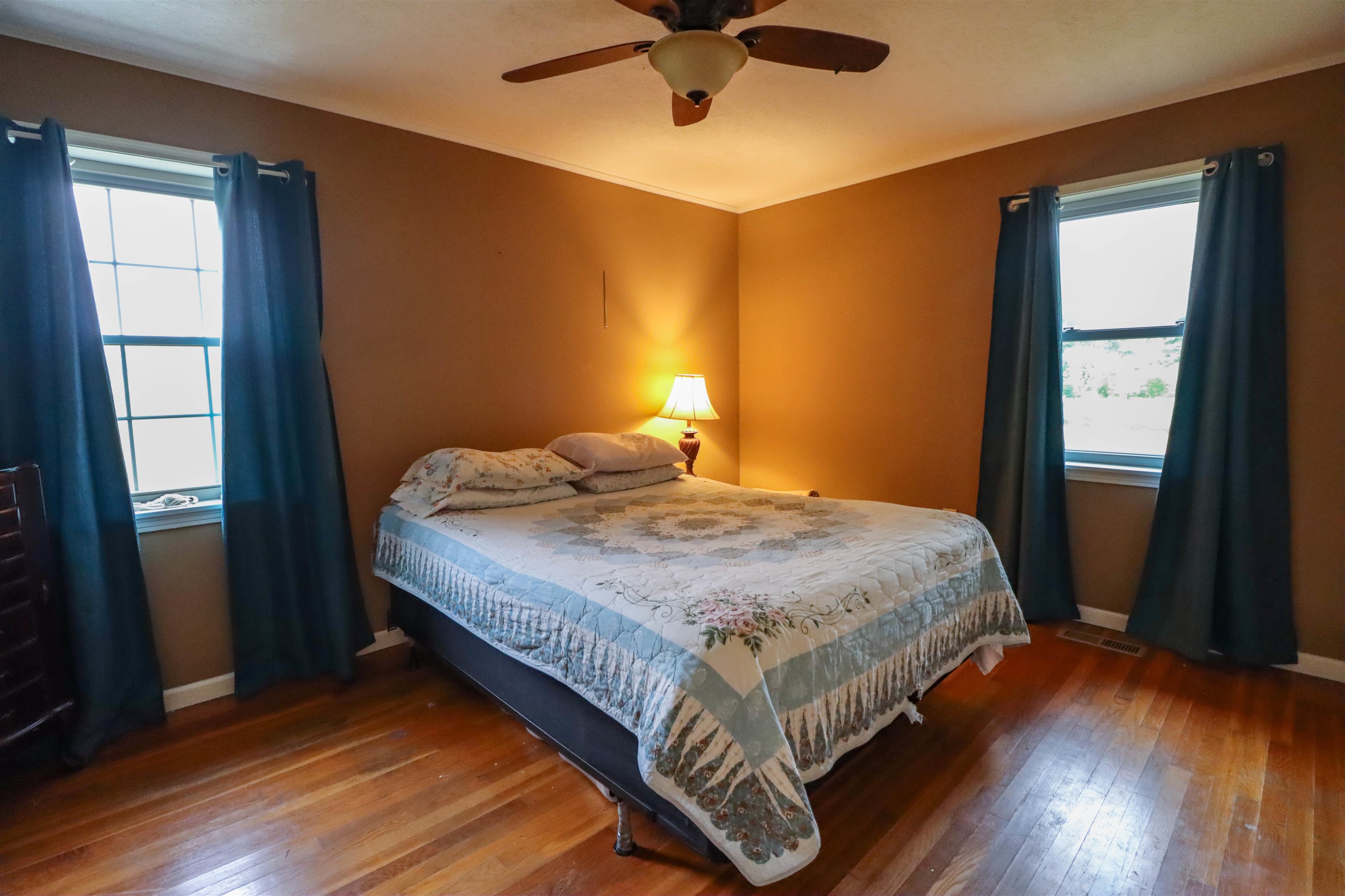 2143 Toulon Road Ripley, TN 38063 - Photo 13 of 39 Primary Bedroom featuring original hardwood floors, ceiling fan, and crown molding.