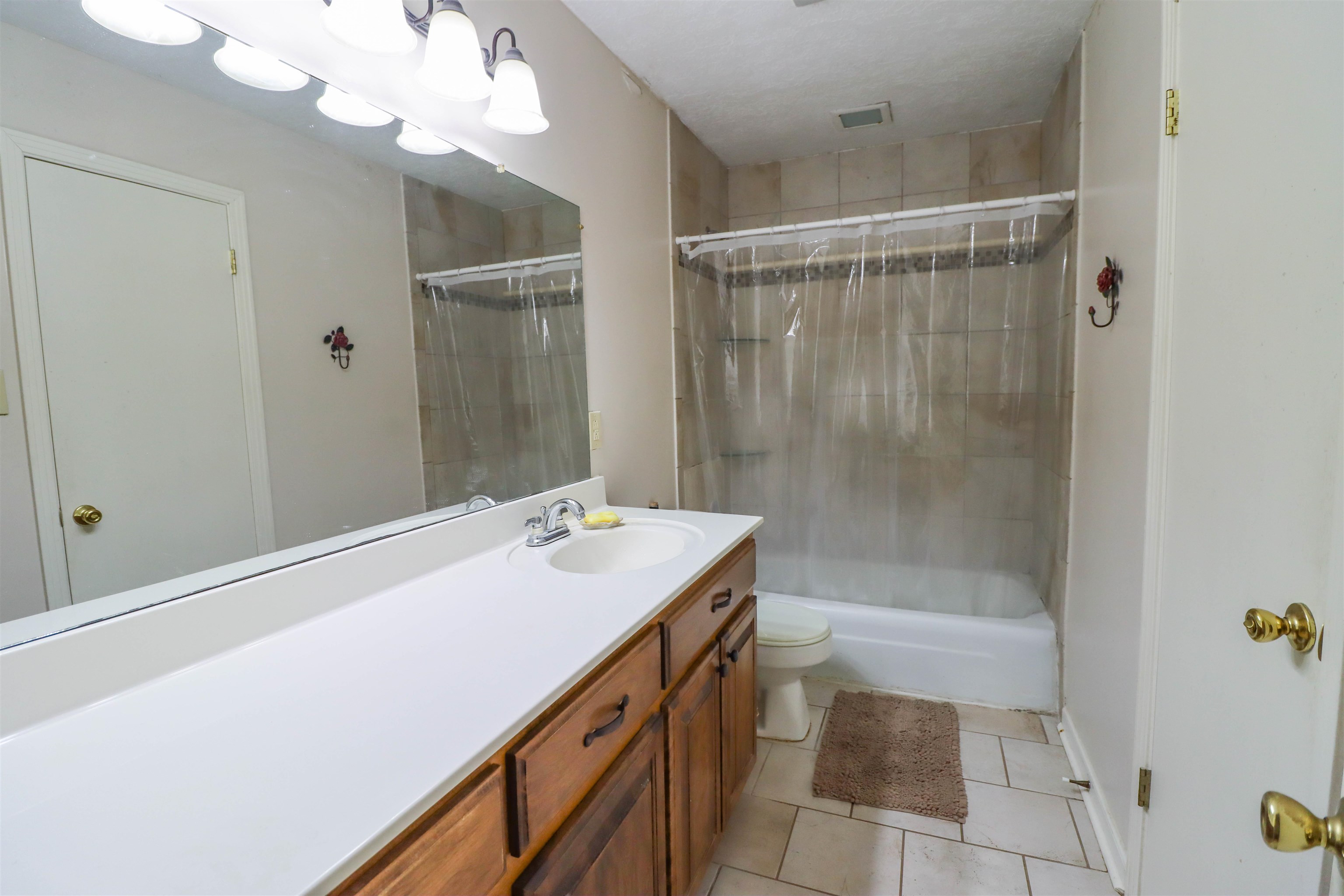 2143 Toulon Road Ripley, TN 38063 - Photo 20 of 39 Bathroom featuring vanity, light tile patterned floors, and combined bath / shower .