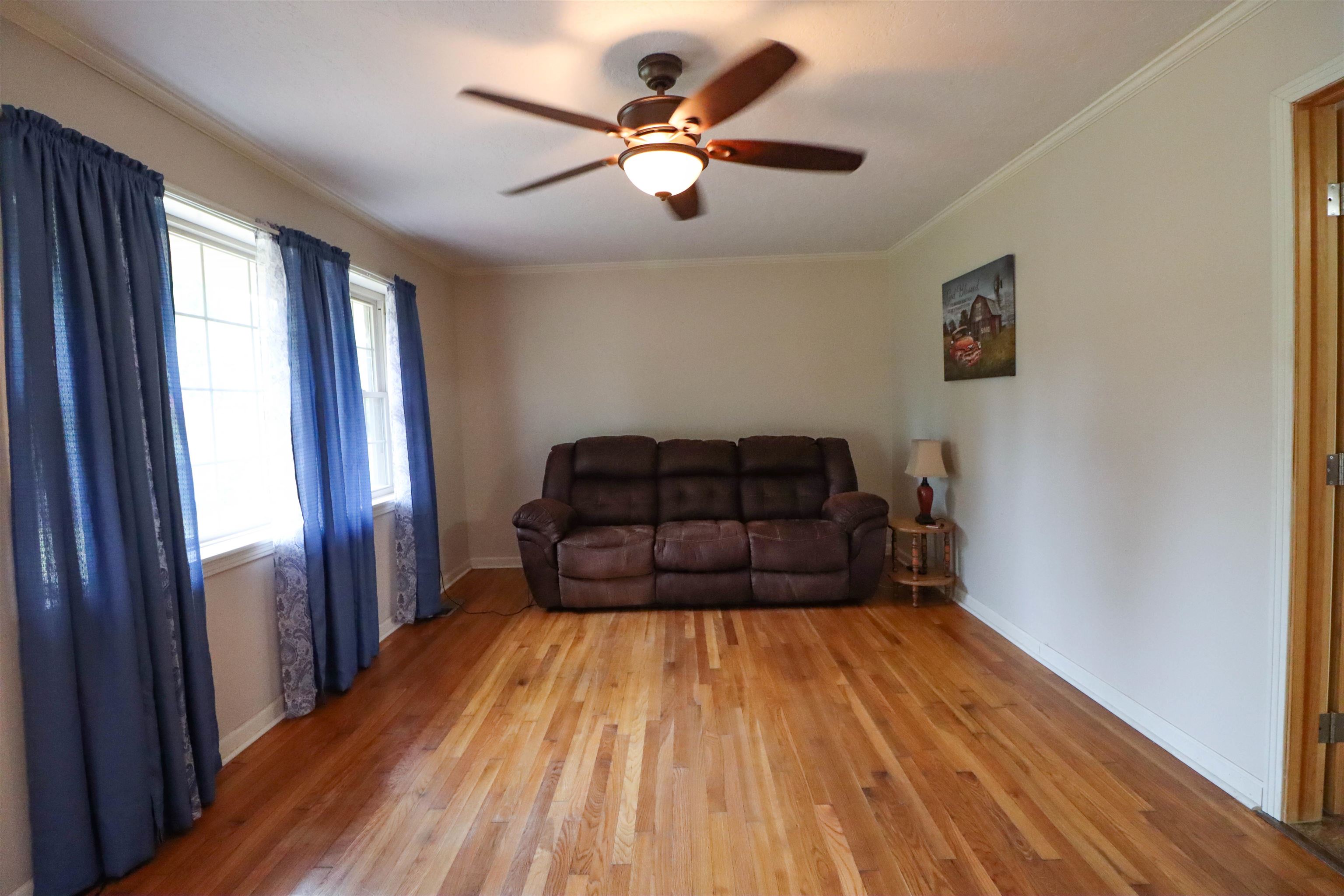 2143 Toulon Road Ripley, TN 38063 - Photo 5 of 39 Living area featuring crown molding, original hardwood flooring, and a ceiling fan