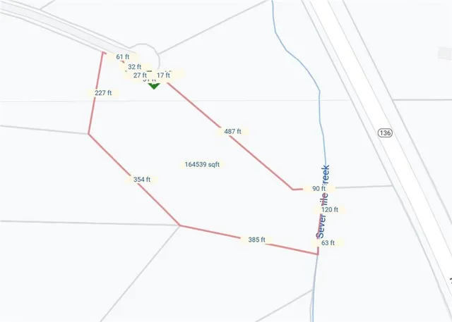 a view of a backyard with large trees