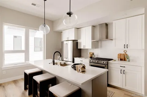 a kitchen with a sink a stove and a window