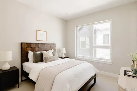 a bedroom with a bed and a couch