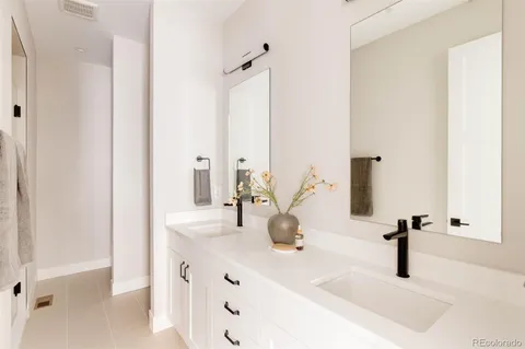 a bathroom with a sink and mirror with toilet