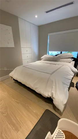 a bedroom with a bed and a night stand