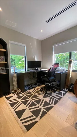 a work space with wooden floor and furniture