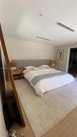 a bedroom with a bed and dresser