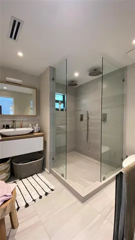 a bathroom with a mirror and a shower