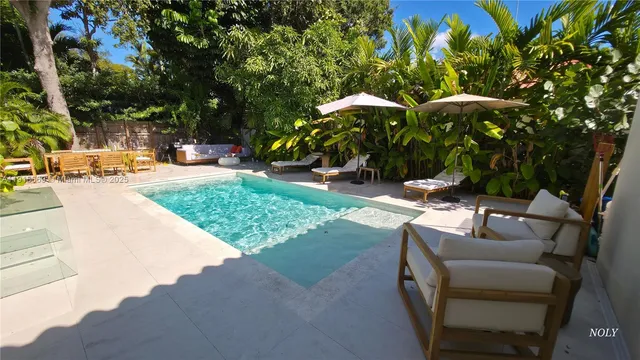 a view of a backyard with a patio and fire pit