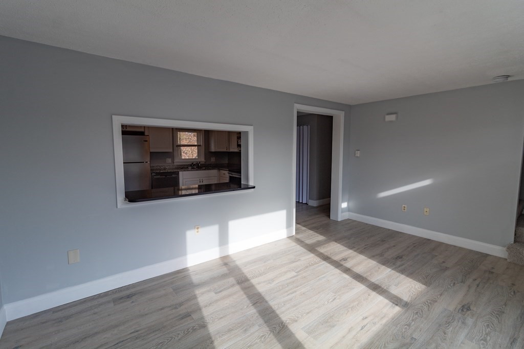 20 Rice Lane, Unit 2 Worcester, MA 01604 - Photo 4 of 17 a hallway with front door wooden floor and windows