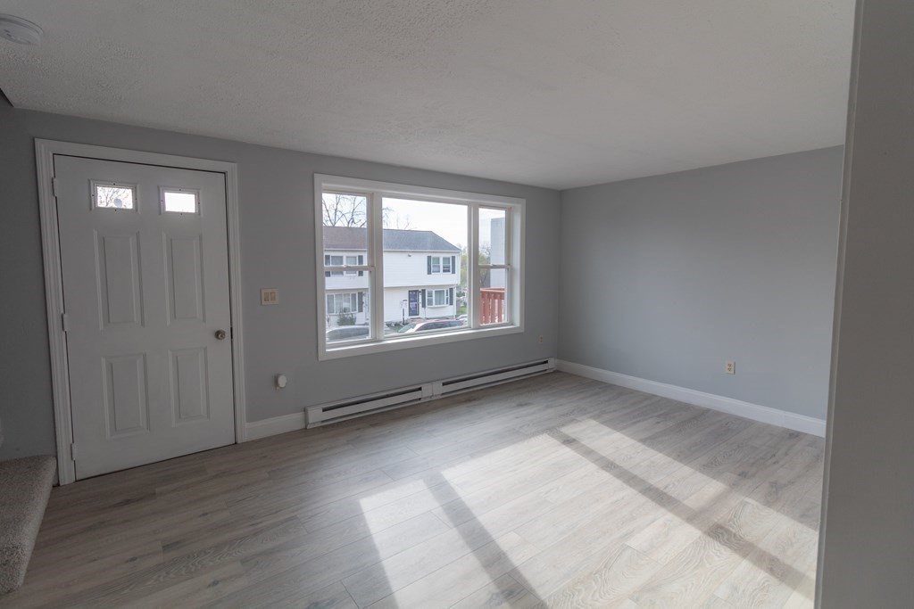 20 Rice Lane, Unit 2 Worcester, MA 01604 - Photo 5 of 17 an empty room with wooden floor and windows