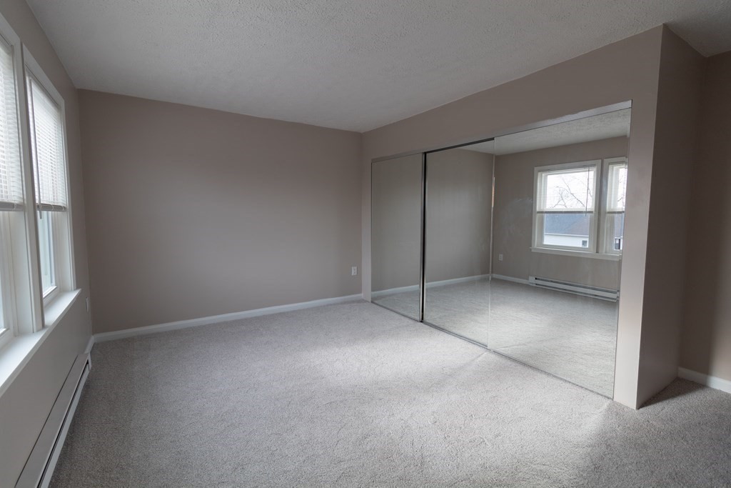 20 Rice Lane, Unit 2 Worcester, MA 01604 - Photo 9 of 17 an empty room with a empty space and windows