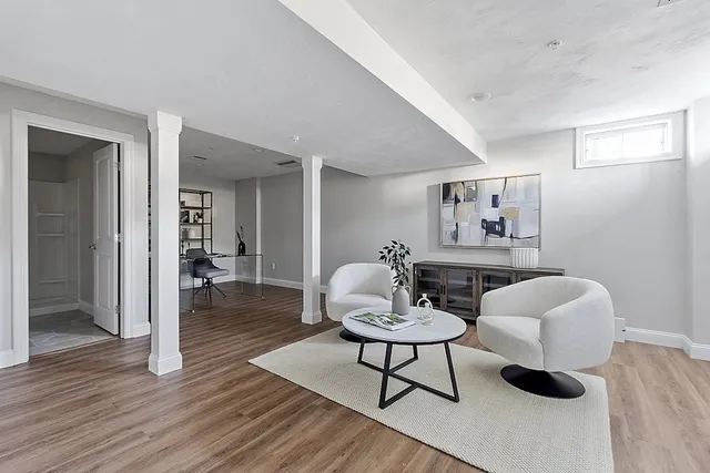 a living room with furniture and a wooden floor