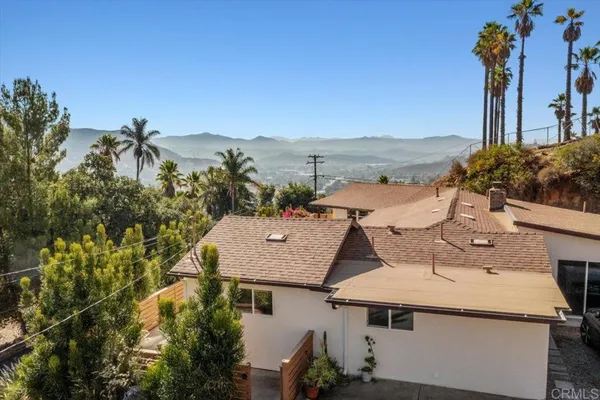 an aerial view of a house with a yard and lake view