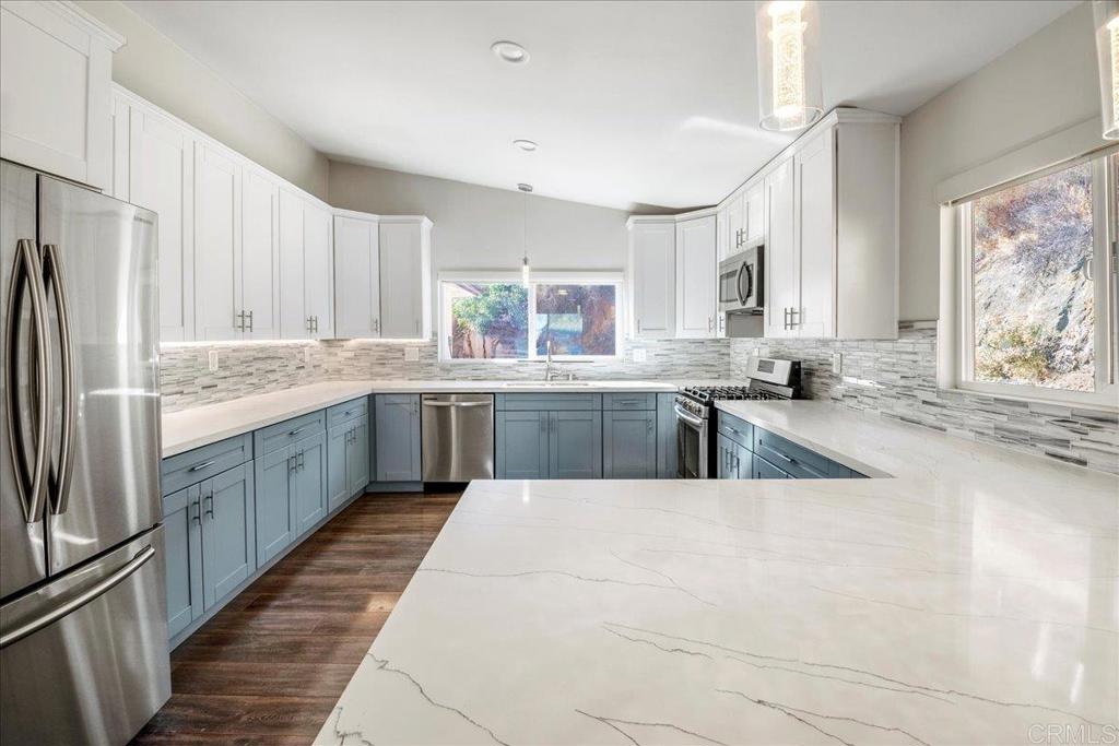 11694 Hi Ridge Road Lakeside, CA 92040 - Photo 13 of 48 a large kitchen with a window and stainless steel appliances