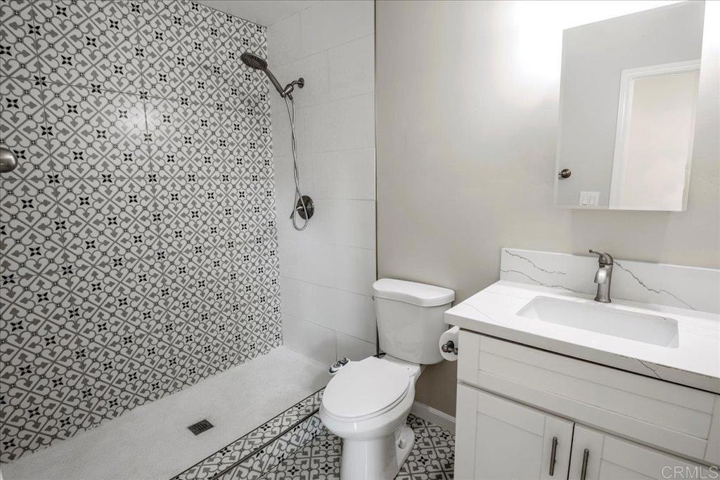 11694 Hi Ridge Road Lakeside, CA 92040 - Photo 16 of 48 a white toilet sitting next to a bathroom sink