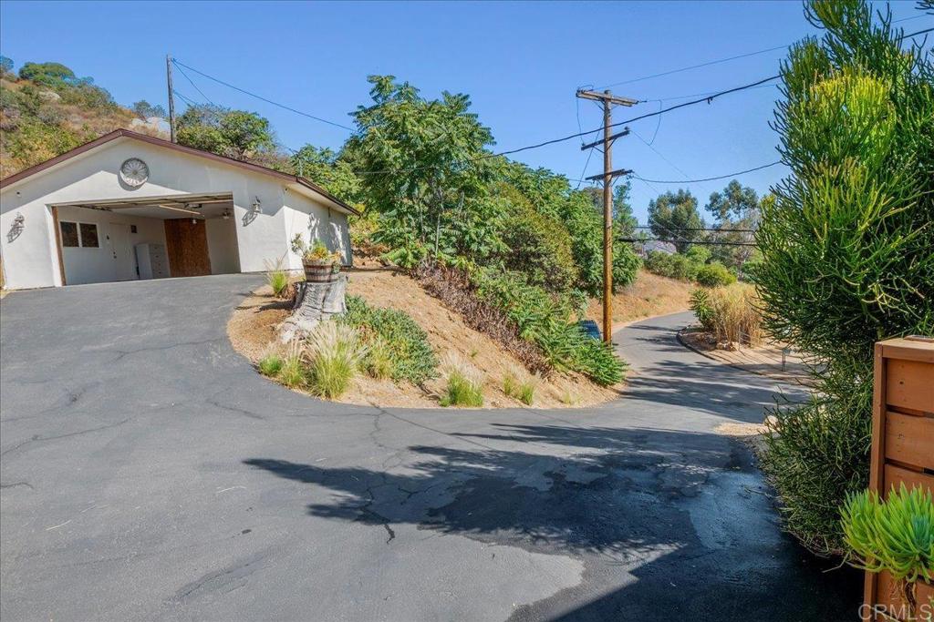 11694 Hi Ridge Road Lakeside, CA 92040 - Photo 3 of 48 a view of a house with a yard and a garage