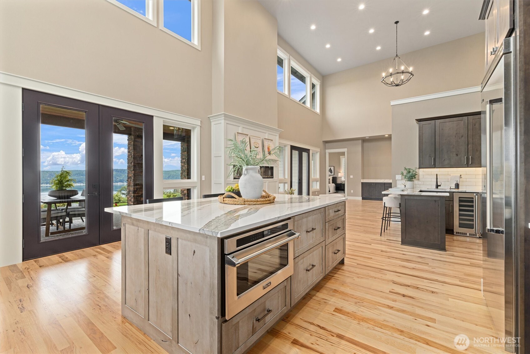 151 East Windy Ridge Lane Belfair, WA 98528 - Photo 10 of 40 a kitchen with stainless steel appliances granite countertop a stove and a wooden floor
