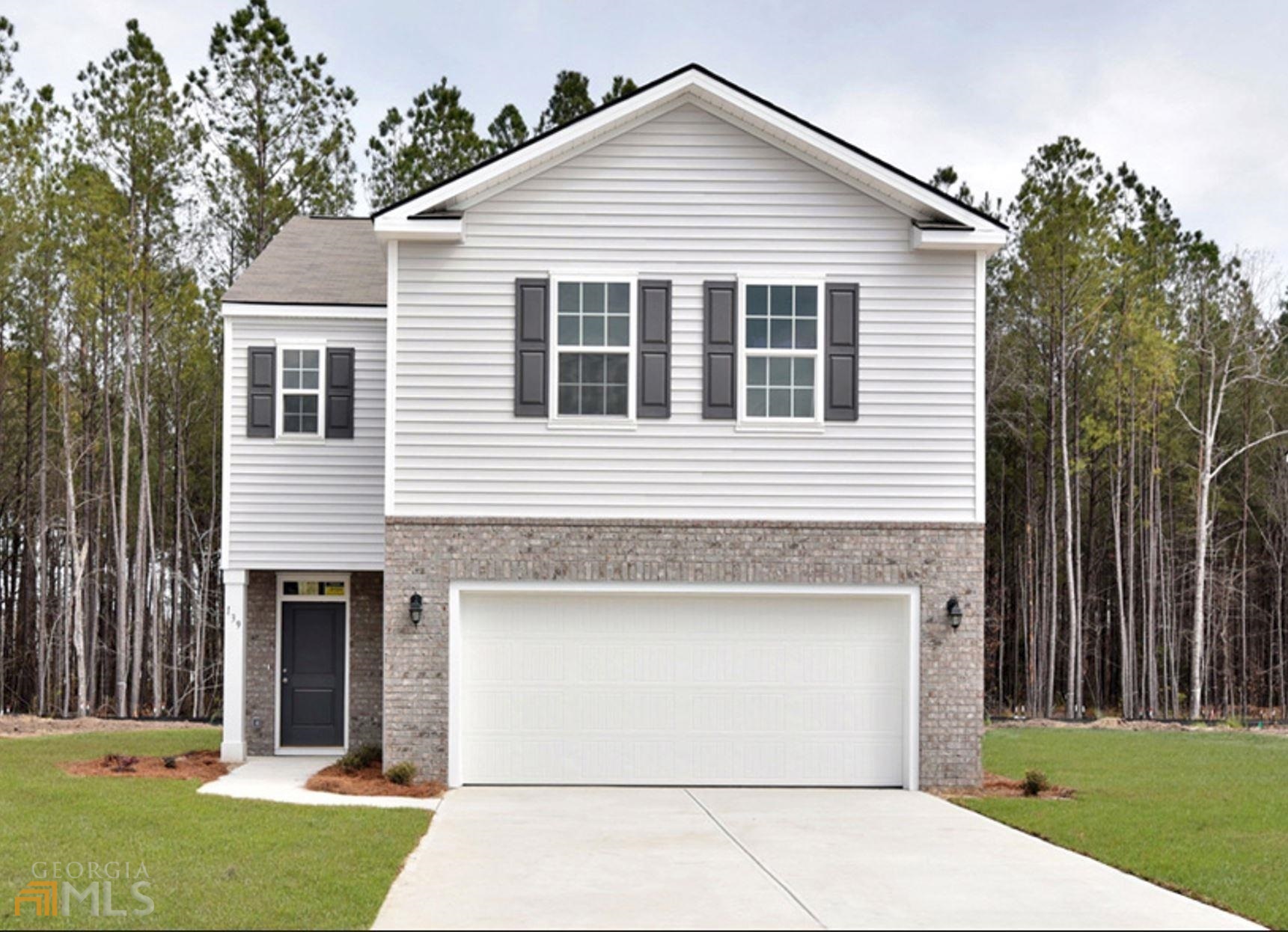 a view of a house with yard and garage