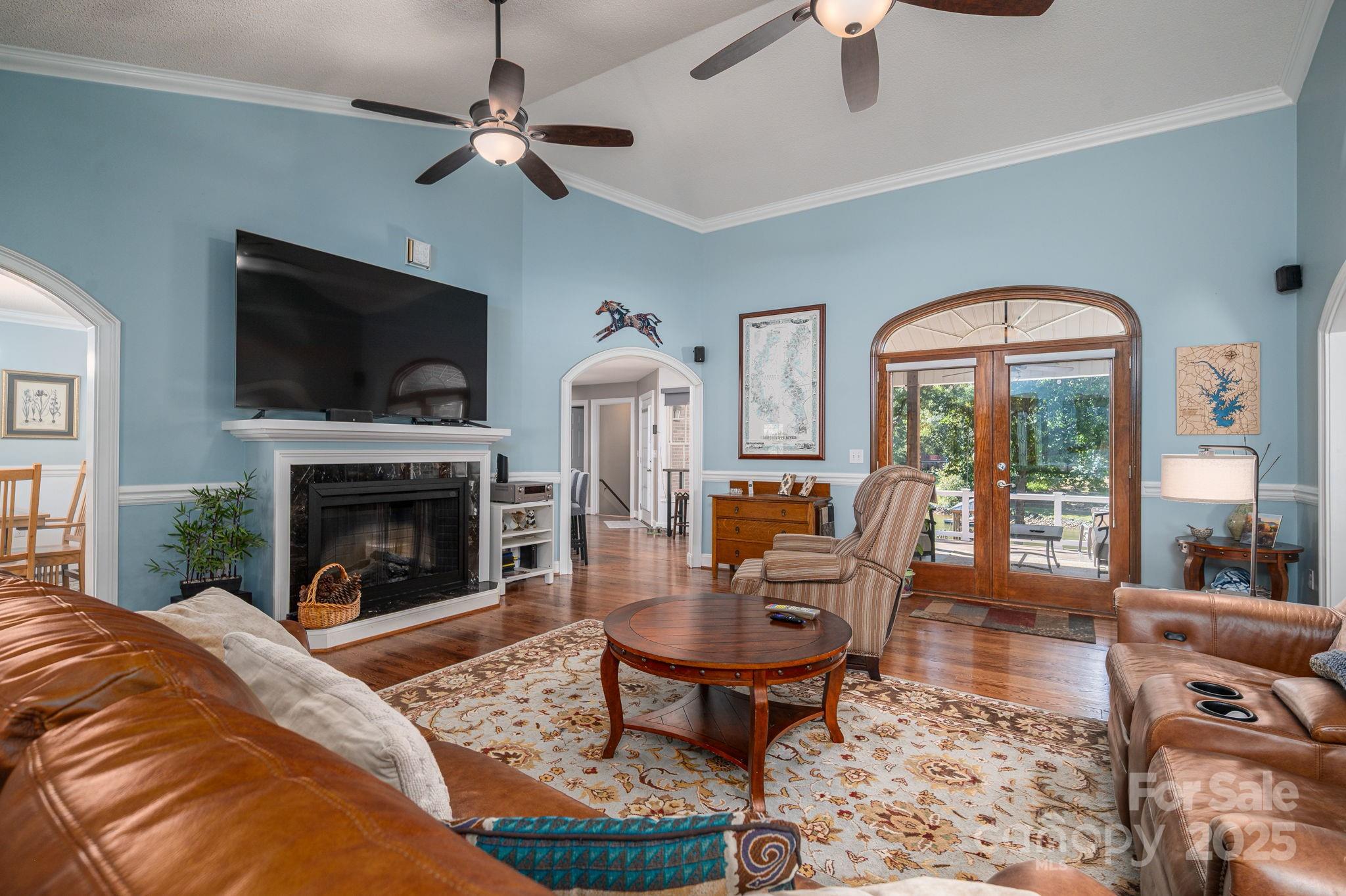 8369 Slate Street Terrell, NC 28682 - Photo 12 of 47 a living room with furniture a flat screen tv and a fireplace