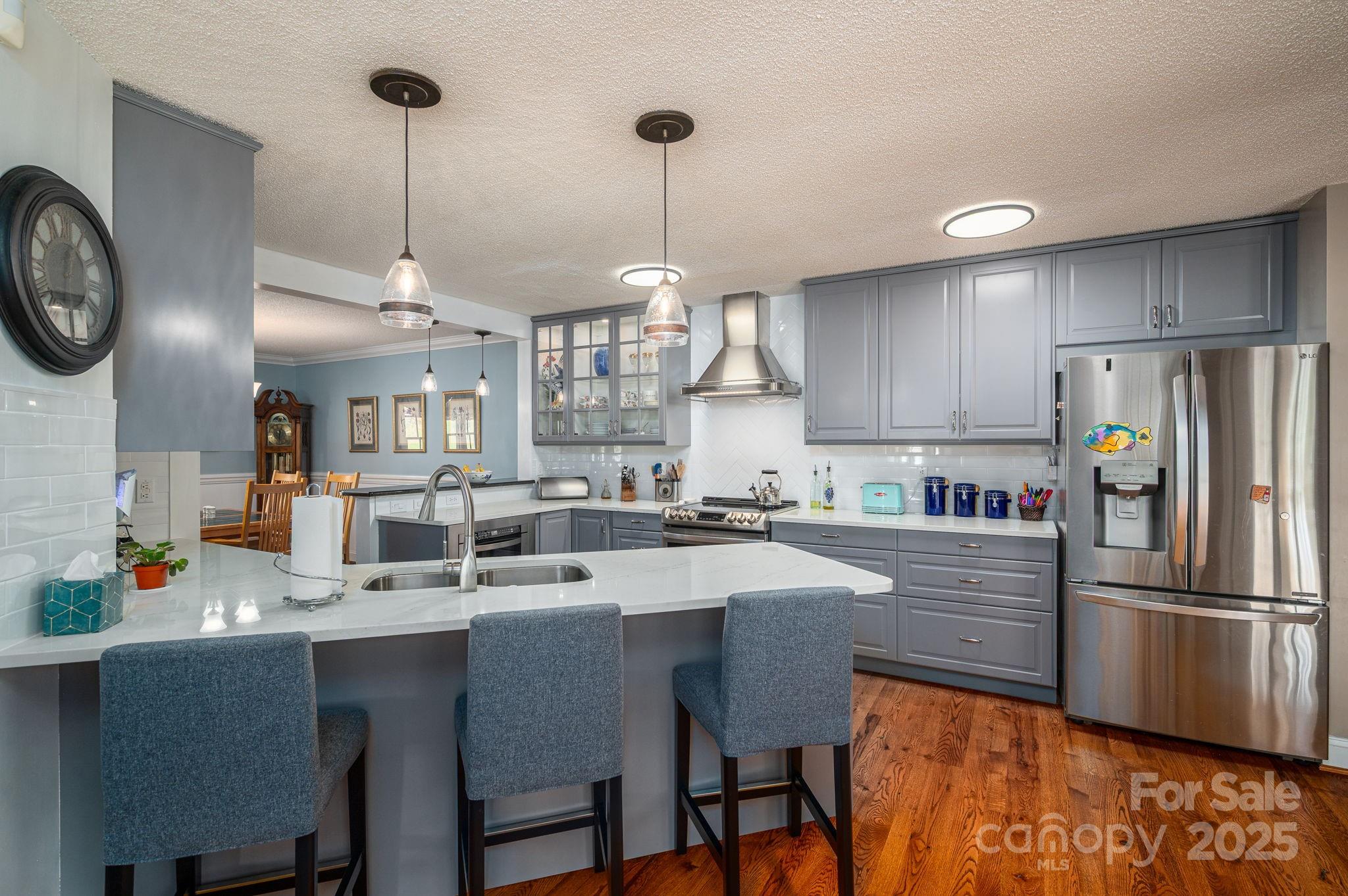 8369 Slate Street Terrell, NC 28682 - Photo 13 of 47 a kitchen with stainless steel appliances a dining table chairs stove and refrigerator