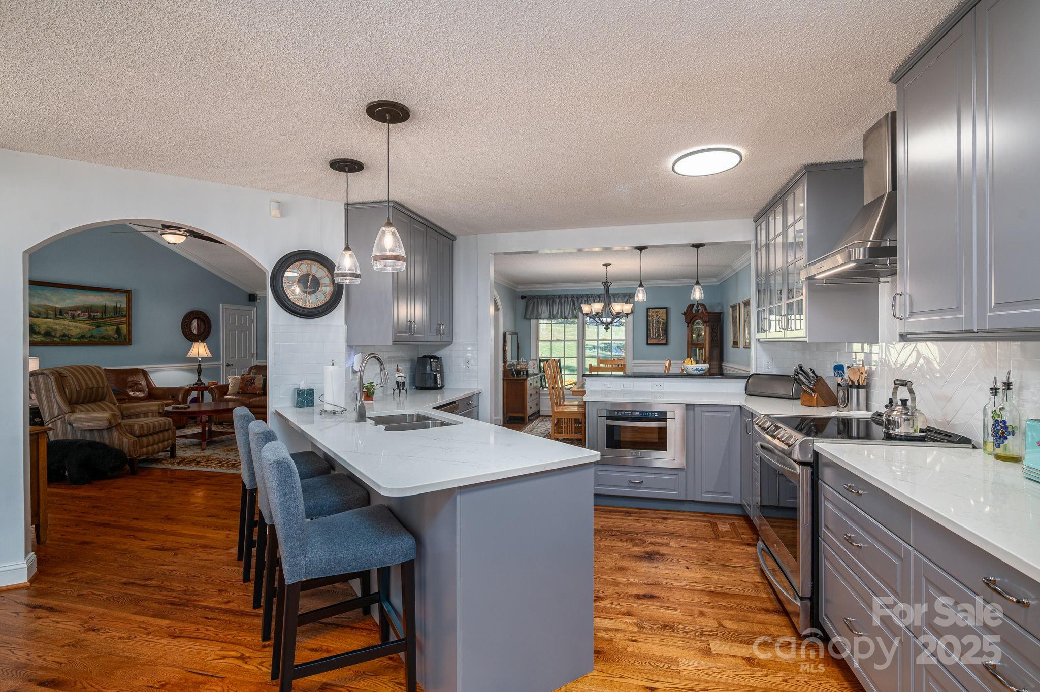 8369 Slate Street Terrell, NC 28682 - Photo 14 of 47 a kitchen with a sink cabinets and wooden floor