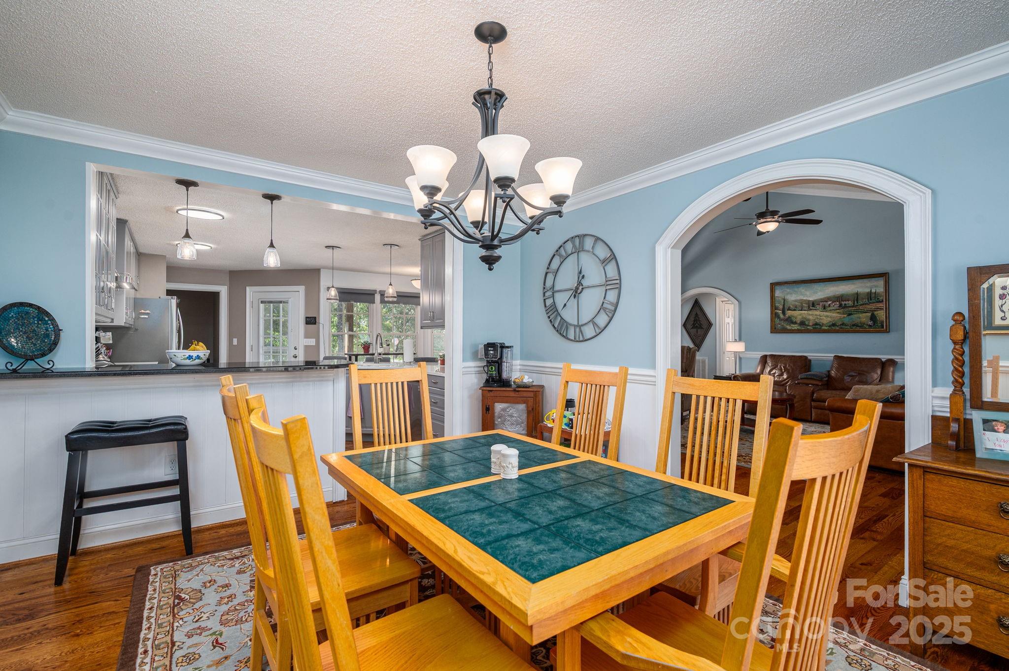 8369 Slate Street Terrell, NC 28682 - Photo 17 of 47 a living room with dining table and a clock