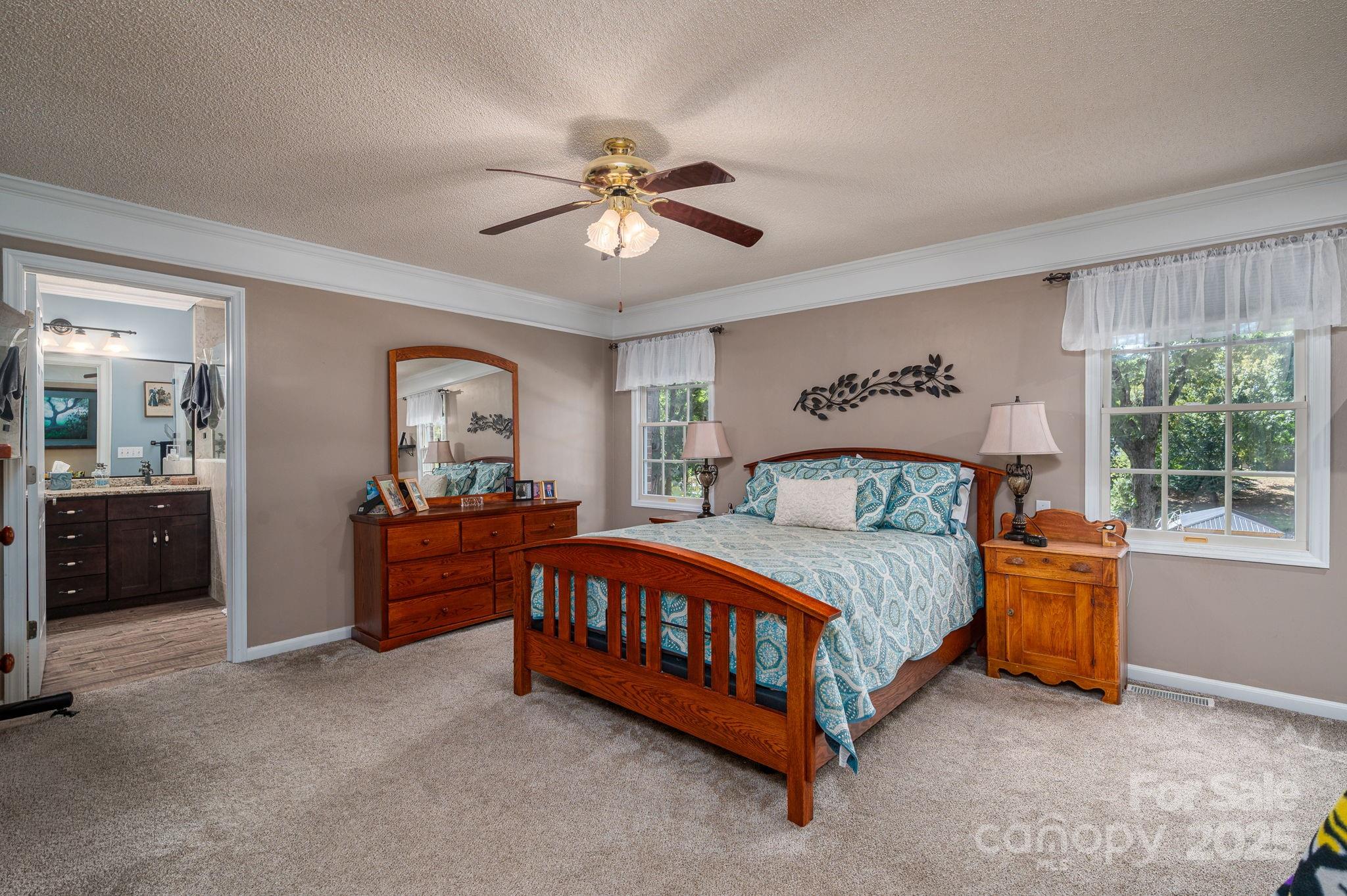 8369 Slate Street Terrell, NC 28682 - Photo 20 of 47 a bedroom with a bed and a chandelier