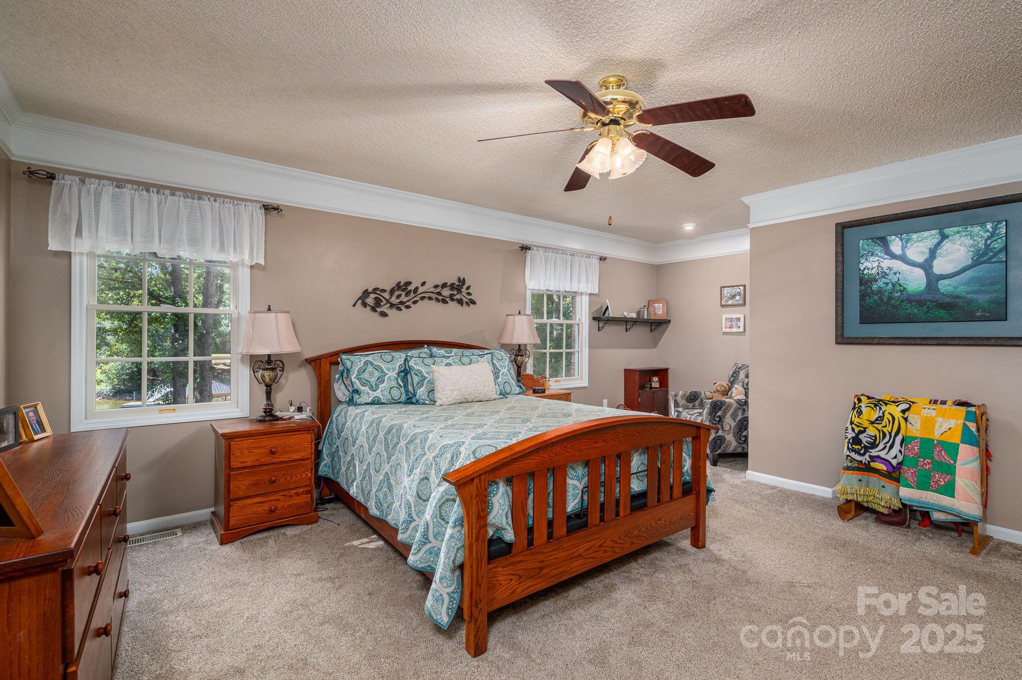 8369 Slate Street Terrell, NC 28682 - Photo 21 of 47 a bedroom with a bed and a chandelier