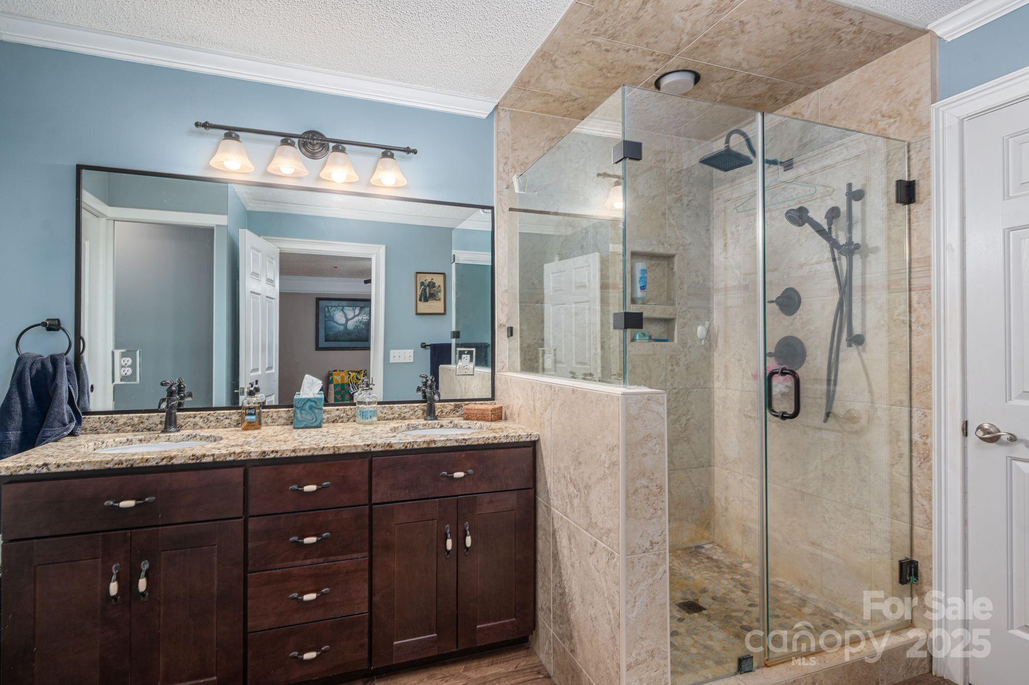 8369 Slate Street Terrell, NC 28682 - Photo 22 of 47 a bathroom with a granite countertop sink mirror and shower