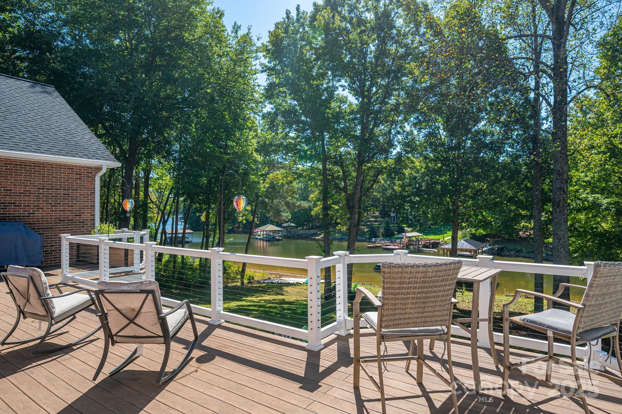 8369 Slate Street Terrell, NC 28682 - Photo 47 of 47 a view of a patio with a dining table and chairs with wooden floor and fence