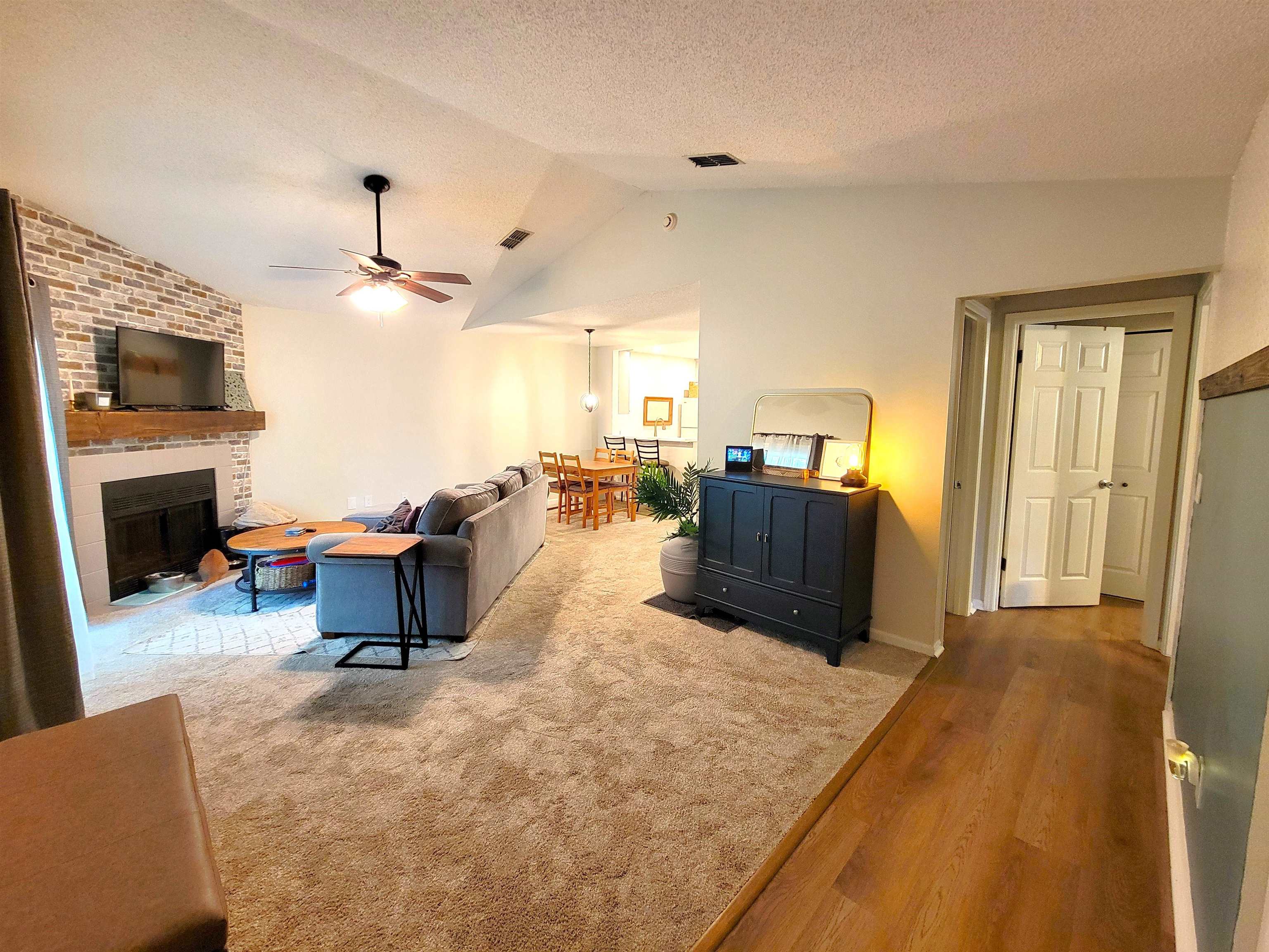 3801 Crown Point Road, Unit 3053 Jacksonville, FL 32257 - Photo 12 of 27 a living room with furniture and a flat screen tv