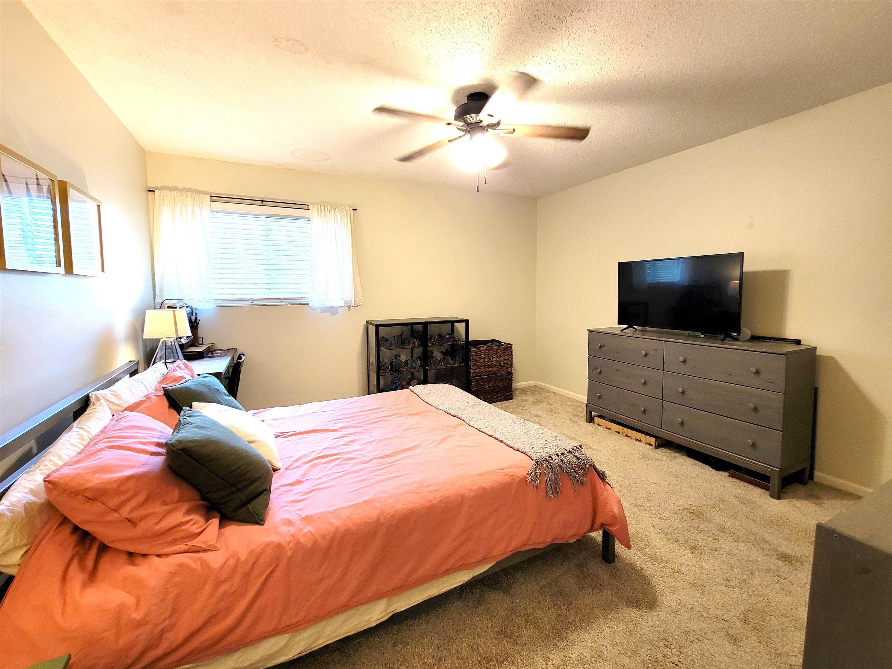 3801 Crown Point Road, Unit 3053 Jacksonville, FL 32257 - Photo 24 of 27 a bedroom with a bed and wooden floor
