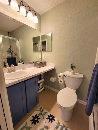 a bathroom with a toilet sink and mirror