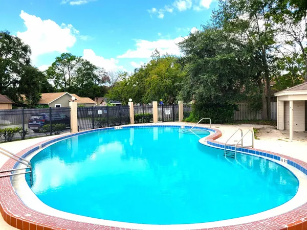 a view of a swimming pool with a yard