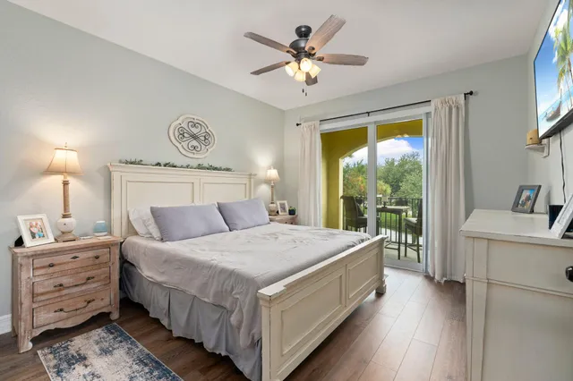 a bedroom with a large bed and a chandelier