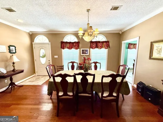 a view of a dining room with furniture and chandelier