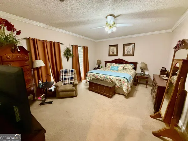 a bedroom with bed and a large window
