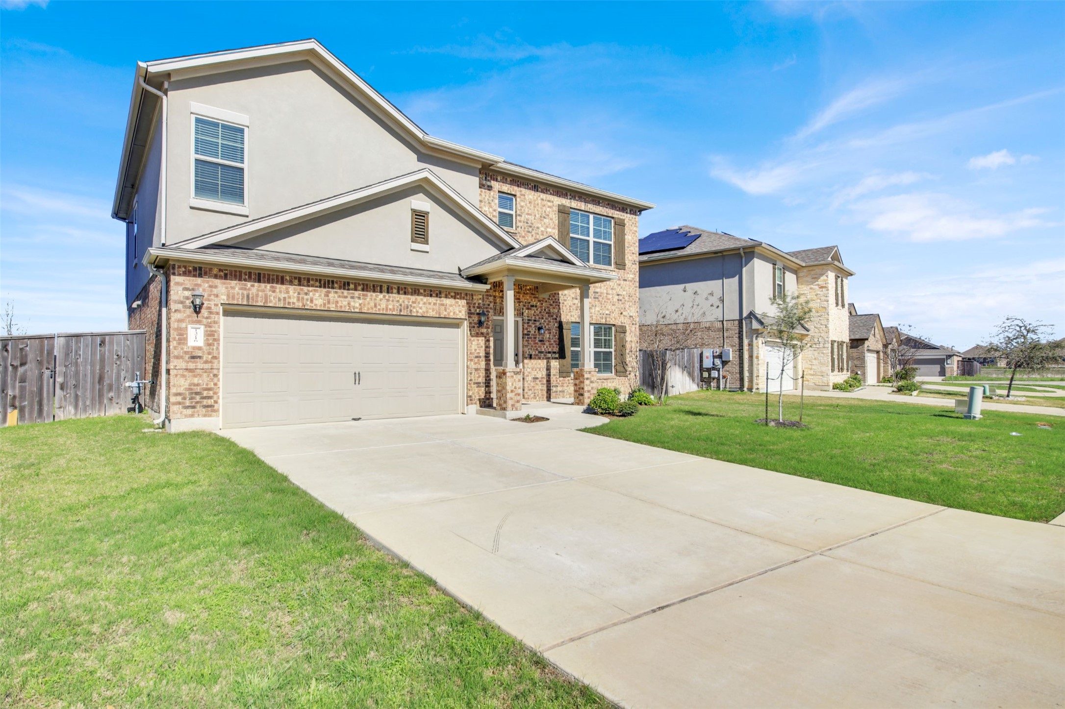 13716 Sugar Bush Path Manor, TX 78653 - Photo 1 of 37 View of front of home with concrete driveway, stucco siding, and brick siding