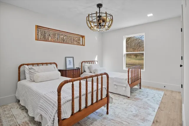 a bedroom with a bed and a chandelier