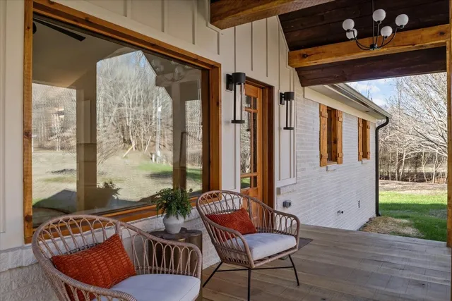 a balcony with furniture and wooden floor