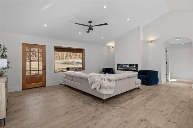 a spacious bedroom with a bed and a large window