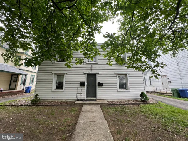 a backyard of a house with large trees