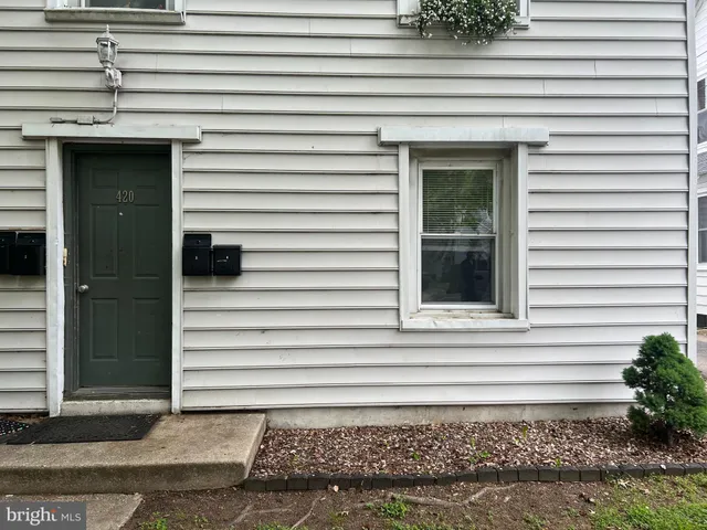 a view of a house with a white door and a wooden door